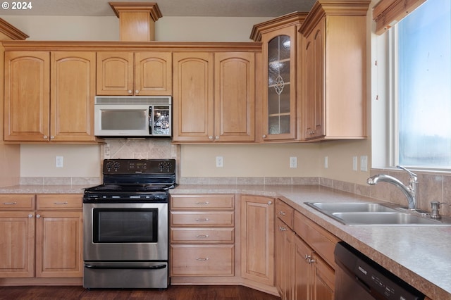 kitchen featuring stainless steel electric range oven, dishwasher, light brown cabinets, and sink