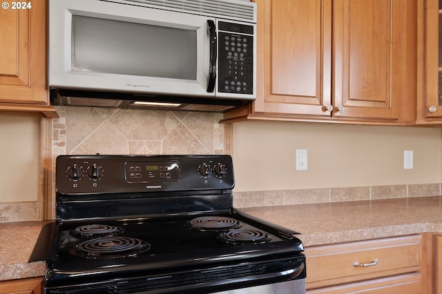 kitchen featuring electric range and decorative backsplash