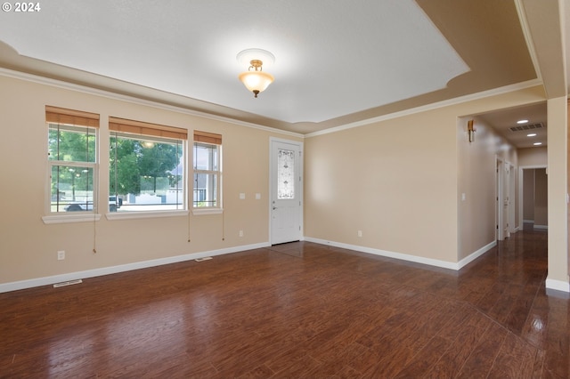 empty room with ornamental molding and dark hardwood / wood-style floors