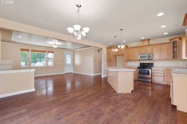 kitchen with stainless steel appliances, an inviting chandelier, hanging light fixtures, and dark hardwood / wood-style floors