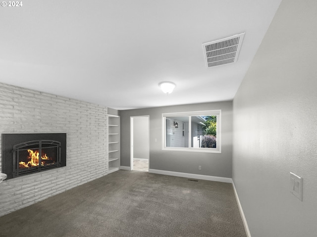 unfurnished living room with carpet flooring, built in shelves, and a fireplace