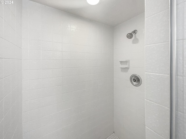 bathroom with a tile shower