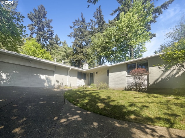 ranch-style house with a front lawn and a garage