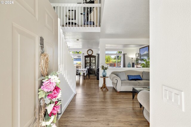 interior space featuring a textured ceiling and hardwood / wood-style flooring