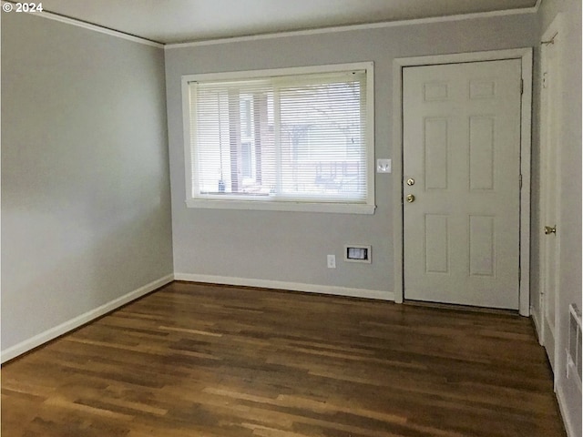 foyer with dark hardwood / wood-style floors and crown molding