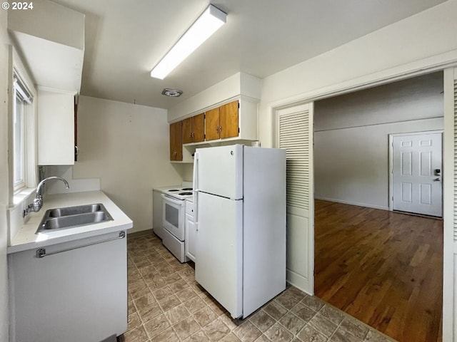 kitchen with white cabinets, light hardwood / wood-style floors, white appliances, and sink