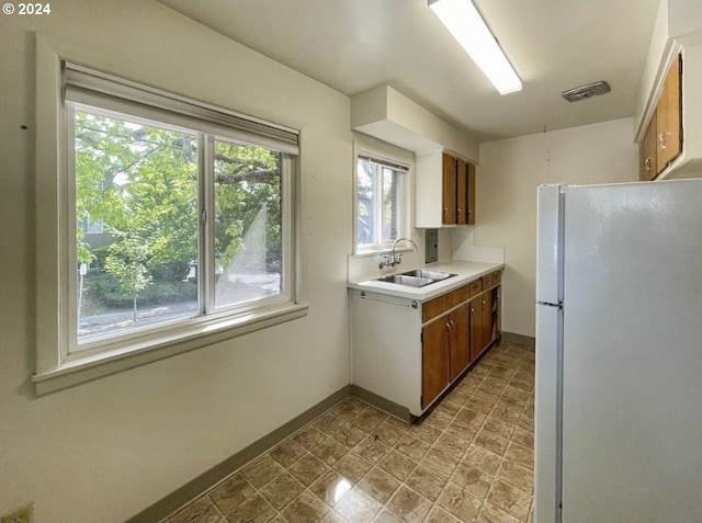 kitchen featuring white fridge and sink