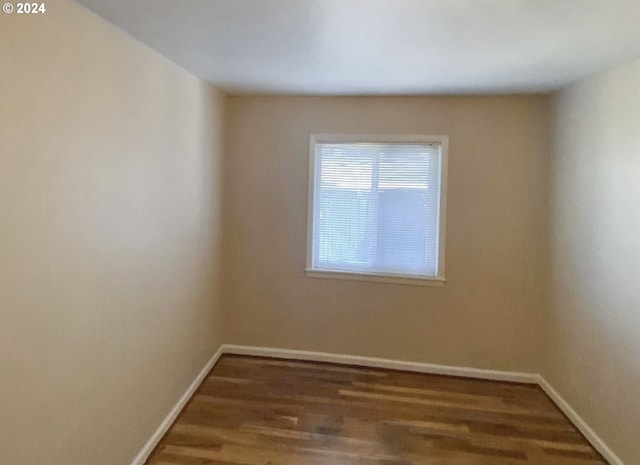 unfurnished room featuring dark hardwood / wood-style flooring