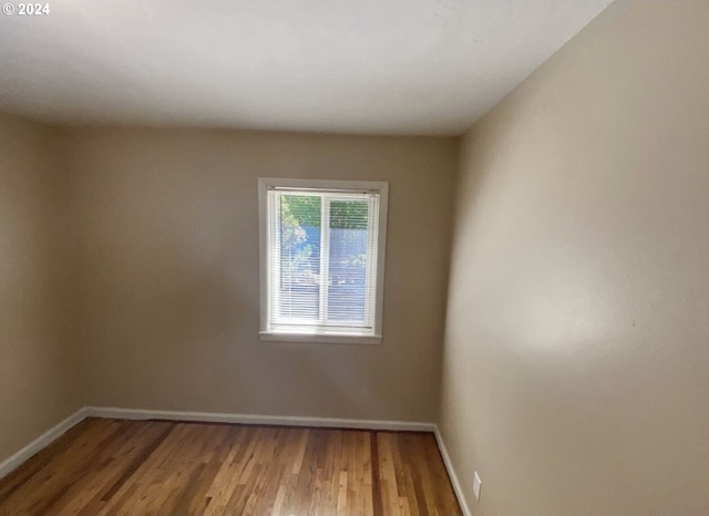 unfurnished room featuring hardwood / wood-style flooring