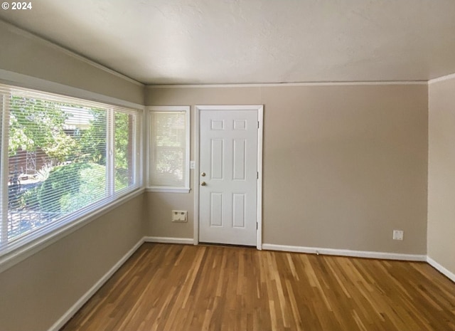 interior space featuring hardwood / wood-style floors and ornamental molding