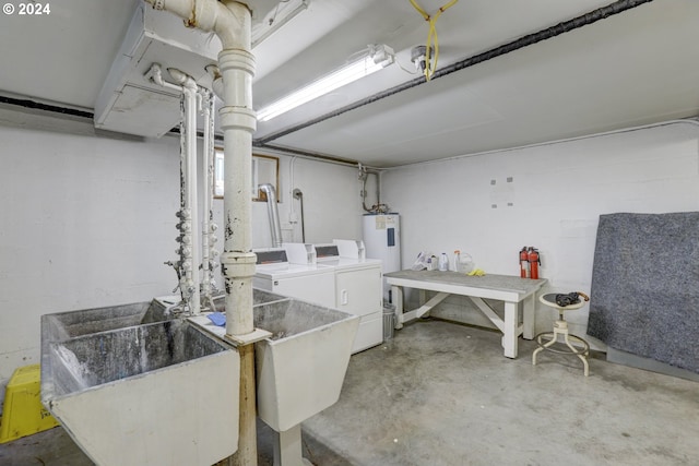 clothes washing area featuring sink, water heater, and washing machine and clothes dryer