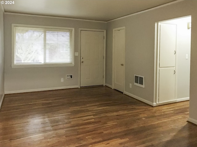 foyer entrance featuring dark hardwood / wood-style flooring and crown molding