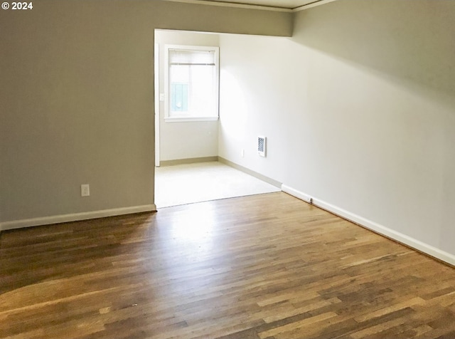 unfurnished room featuring dark hardwood / wood-style flooring