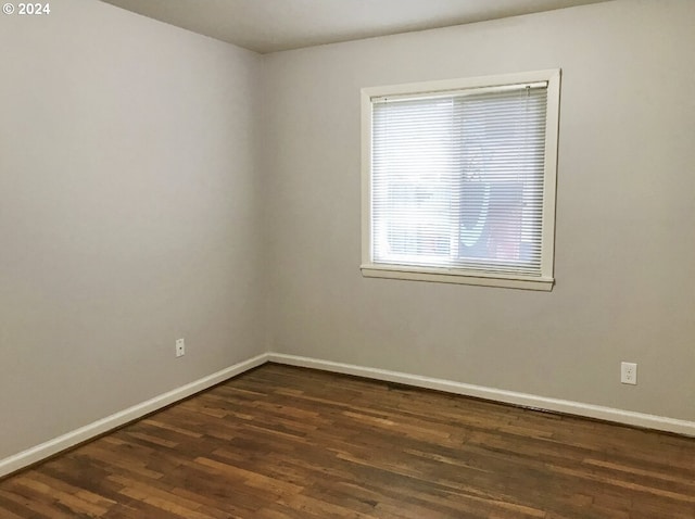 spare room with dark hardwood / wood-style flooring