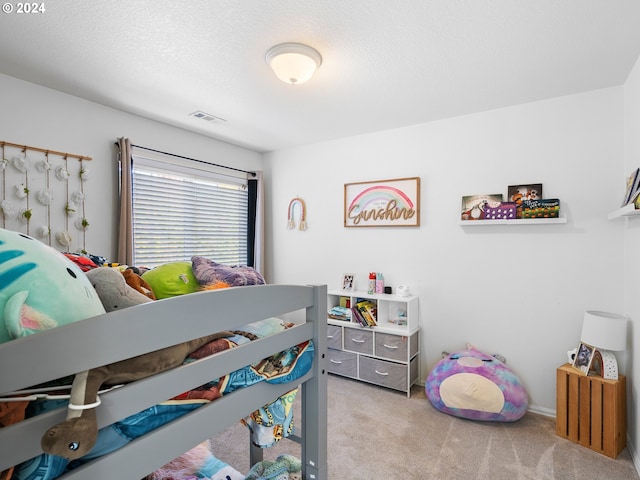 carpeted bedroom with a textured ceiling