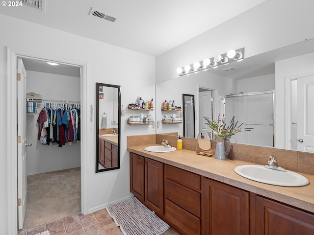 bathroom featuring walk in shower and vanity