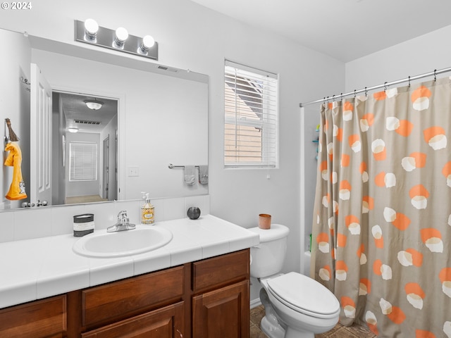 full bathroom with shower / bath combo, vanity, and toilet