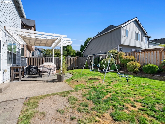 view of yard with a playground, a pergola, and a patio area