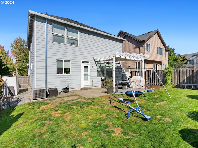 rear view of property featuring a patio, a pergola, central air condition unit, and a yard