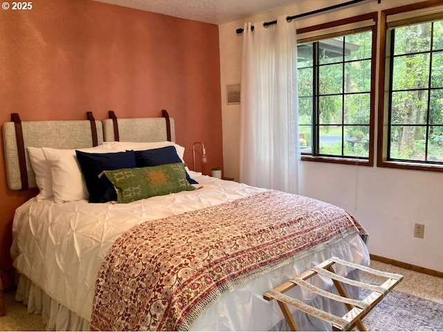 68191 E Twinberry Loop, Welches, OR 97067 - bedroom featuring multiple windows, baseboards, and carpet