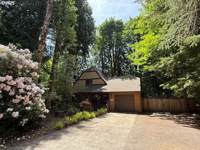 68191 E Twinberry Loop, Welches, OR 97067 - view of front facade featuring a garage and concrete driveway