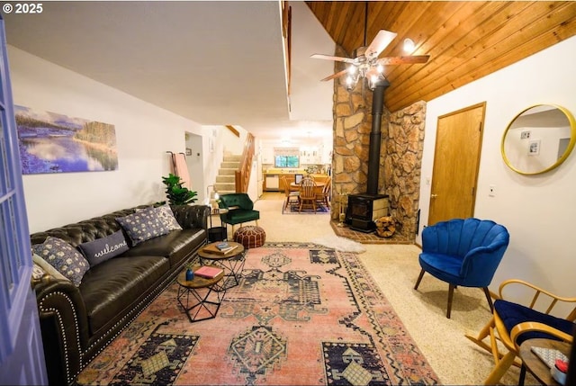 68191 E Twinberry Loop, Welches, OR 97067 - living area featuring a wood stove, carpet flooring, stairway, and ceiling fan