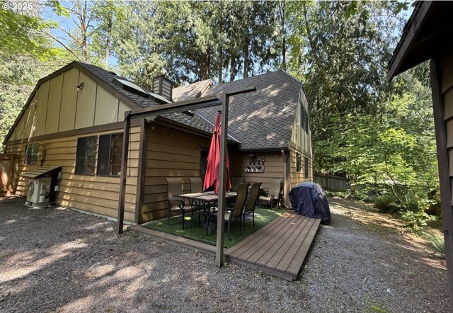68191 E Twinberry Loop, Welches, OR 97067 - back of property featuring a shingled roof, a chimney, board and batten siding, and outdoor dining space