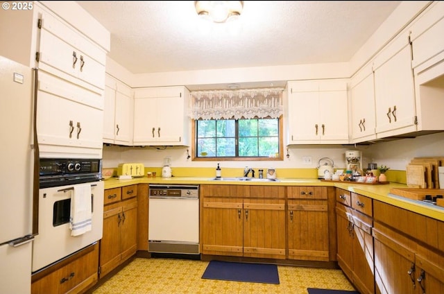 68191 E Twinberry Loop, Welches, OR 97067 - kitchen featuring white appliances, a sink, light countertops, and white cabinetry