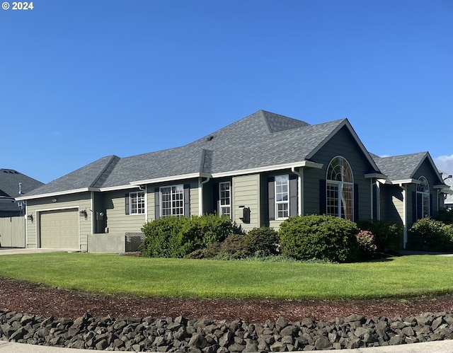 single story home featuring a front yard and a garage