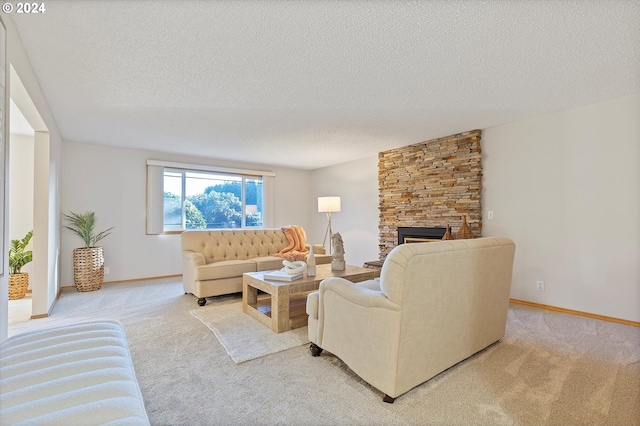 living room featuring a textured ceiling, light colored carpet, and a stone fireplace