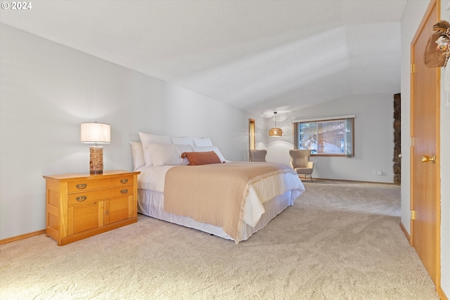 bedroom featuring a textured ceiling, vaulted ceiling, and light colored carpet