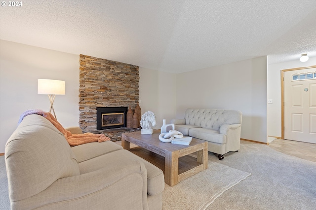 living room with light carpet, a stone fireplace, and a textured ceiling