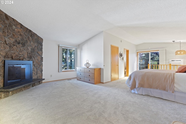 carpeted bedroom featuring a textured ceiling, a stone fireplace, and lofted ceiling