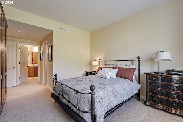 carpeted bedroom with ensuite bathroom