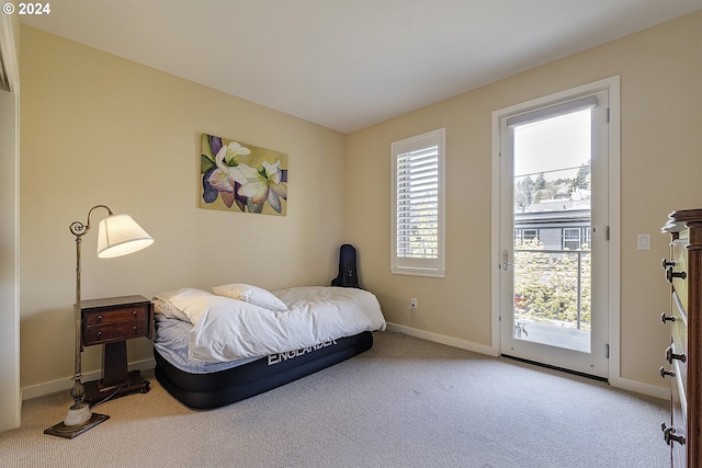 bedroom with access to exterior and carpet floors