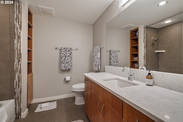 full bathroom featuring tile patterned flooring, vanity, tiled shower / bath combo, and toilet