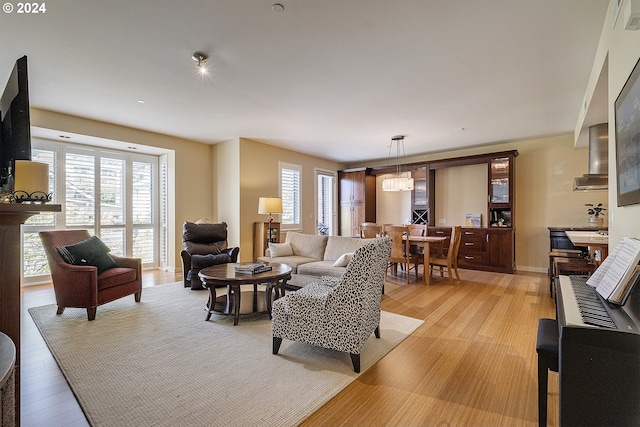 living room with a chandelier and light hardwood / wood-style floors