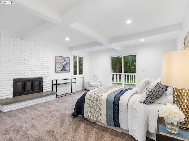 bedroom with beamed ceiling, access to outside, carpet, and a fireplace