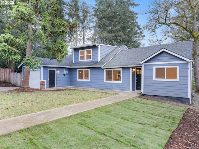 view of front of property with a garage and a front yard