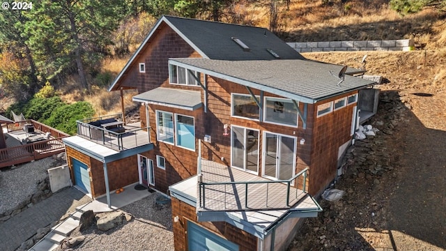 rear view of house featuring a garage