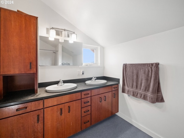 bathroom with vanity and lofted ceiling