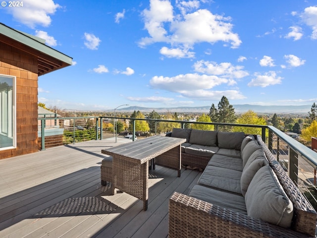 wooden terrace featuring outdoor lounge area