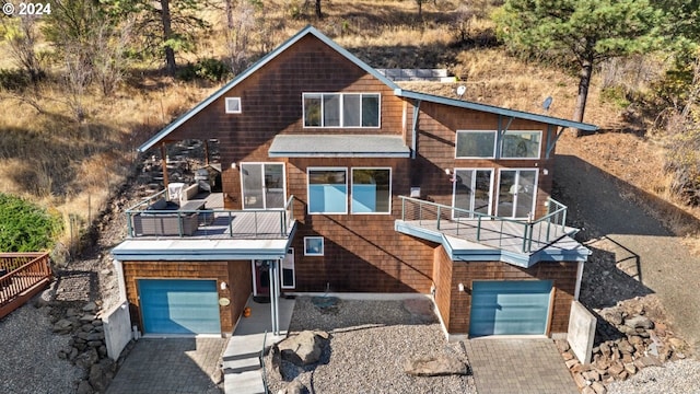 view of front of house featuring a garage and a balcony