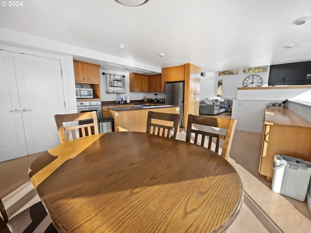 carpeted dining space with sink