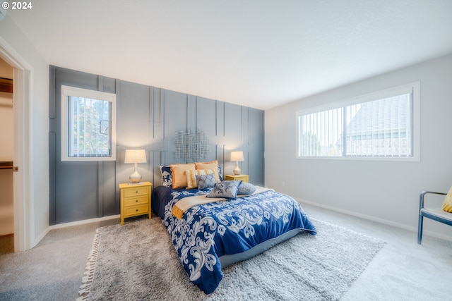 carpeted bedroom featuring multiple windows