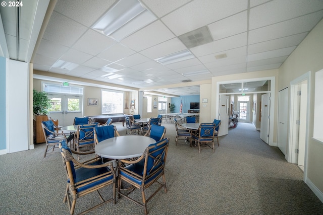 dining space with french doors, a paneled ceiling, and carpet flooring