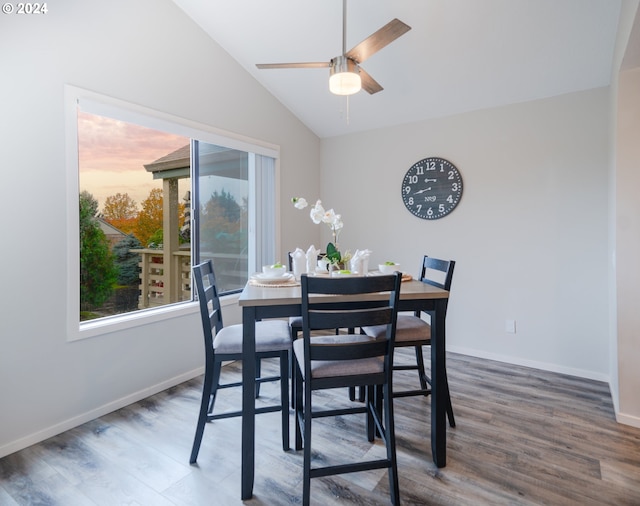 dining space featuring lofted ceiling, dark hardwood / wood-style floors, and ceiling fan