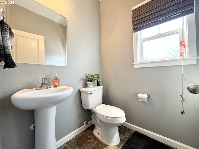 bathroom with toilet and tile patterned flooring