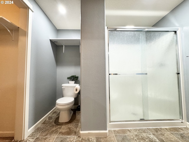 bathroom featuring toilet and walk in shower