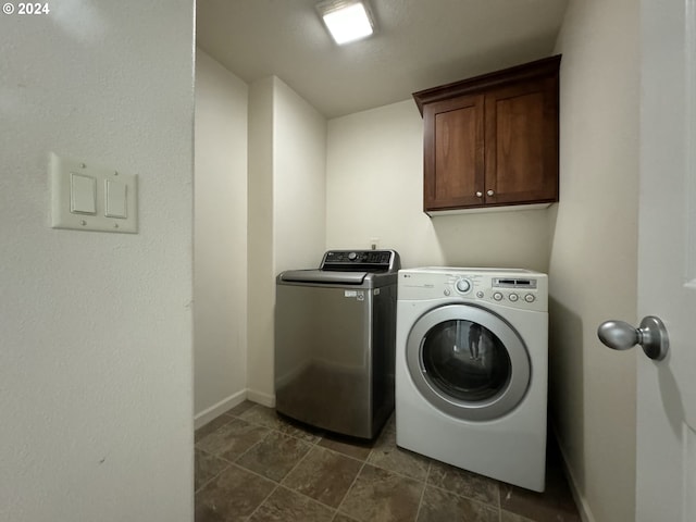 washroom featuring washer and dryer and cabinets